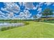 Scenic community lakefront with walking path and clubhouse at 6137 Voyagers Pl, Apollo Beach, FL 33572