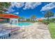 Community pool with lounge chairs and umbrellas at 6137 Voyagers Pl, Apollo Beach, FL 33572