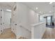 Bright upstairs hallway with light wood stairs and multiple doors at 6137 Voyagers Pl, Apollo Beach, FL 33572