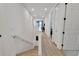 Long upstairs hallway with light wood stairs and access to bedrooms at 6137 Voyagers Pl, Apollo Beach, FL 33572