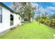 Large grassy backyard with a view of the house at 6141 Ridgewood Dr, Zephyrhills, FL 33542