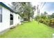 Large grassy backyard with a view of the house at 6141 Ridgewood Dr, Zephyrhills, FL 33542