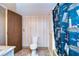 Bathroom with toilet and shower, featuring a nautical theme at 6141 Ridgewood Dr, Zephyrhills, FL 33542