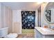 Bathroom with vanity, toilet, shower, and nautical shower curtain at 6141 Ridgewood Dr, Zephyrhills, FL 33542