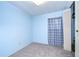 Light blue bedroom with carpet, window, and closet at 6141 Ridgewood Dr, Zephyrhills, FL 33542