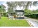 Mobile home with carport and lush landscaping at 6141 Ridgewood Dr, Zephyrhills, FL 33542