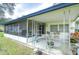 Covered front porch with metal railings and seating at 6141 Ridgewood Dr, Zephyrhills, FL 33542