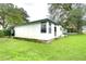 View of a white single-story house's exterior at 6141 Ridgewood Dr, Zephyrhills, FL 33542