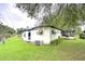 White single-story house with a screened porch at 6141 Ridgewood Dr, Zephyrhills, FL 33542