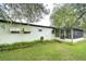 Back of a white single-story house with a screened porch at 6141 Ridgewood Dr, Zephyrhills, FL 33542