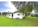 White single-story house with a screened porch at 6141 Ridgewood Dr, Zephyrhills, FL 33542