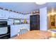 Kitchen with white cabinets, black appliances, and a view into the dining area at 6141 Ridgewood Dr, Zephyrhills, FL 33542