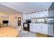 White kitchen cabinets, black appliances and view of dining area at 6141 Ridgewood Dr, Zephyrhills, FL 33542