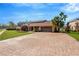 House with a large paved driveway and lush lawn at 6151 Silver Oaks Dr, Zephyrhills, FL 33542