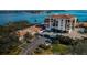 Aerial view of waterfront condo building with parking and landscaping at 6218 Palma Del Mar S Blvd # 208, St Petersburg, FL 33715