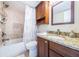 Clean bathroom with shower/tub combo, granite vanity, and updated fixtures at 6218 Palma Del Mar S Blvd # 208, St Petersburg, FL 33715