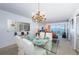 Bright dining room with glass table and chandelier at 6218 Palma Del Mar S Blvd # 208, St Petersburg, FL 33715