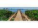 Long wooden walkway leads to a pier, offering waterfront access at 6218 Palma Del Mar S Blvd # 208, St Petersburg, FL 33715