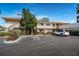 Condo building with parking spaces and tropical foliage at 6218 Palma Del Mar S Blvd # 208, St Petersburg, FL 33715