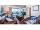 Living room with leather sofas, coffee table, and water views at 6218 Palma Del Mar S Blvd # 208, St Petersburg, FL 33715