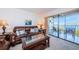 Living room with leather sofas, coffee table, and water views at 6218 Palma Del Mar S Blvd # 208, St Petersburg, FL 33715