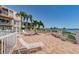 Community patio area with white lounge chairs and waterfront views at 6218 Palma Del Mar S Blvd # 208, St Petersburg, FL 33715