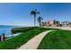 Paved waterfront walkway with lush landscaping and kayaks at 6218 Palma Del Mar S Blvd # 208, St Petersburg, FL 33715