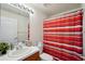 Clean bathroom with a striped shower curtain and a single sink vanity at 6325 Chapel Pines Blvd, Wesley Chapel, FL 33545