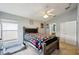 Bright bedroom with wooden bed frame, carpet flooring and ceiling fan at 6325 Chapel Pines Blvd, Wesley Chapel, FL 33545