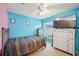 Light blue bedroom with a bed, dresser, and TV at 6325 Chapel Pines Blvd, Wesley Chapel, FL 33545