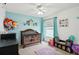 bedroom with crib, toys, and colorful decor at 6325 Chapel Pines Blvd, Wesley Chapel, FL 33545