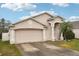 Beautiful one-story house with a two-car garage and a well-manicured lawn at 6325 Chapel Pines Blvd, Wesley Chapel, FL 33545