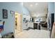 Open concept kitchen with white cabinets and view into the living room at 6325 Chapel Pines Blvd, Wesley Chapel, FL 33545