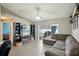 Living room with L-shaped sofa, sliding doors to patio, and wood-look floors at 6325 Chapel Pines Blvd, Wesley Chapel, FL 33545