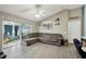 Relaxing living room with a large sectional sofa and access to a screened patio at 6325 Chapel Pines Blvd, Wesley Chapel, FL 33545