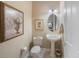 Elegant powder room with pedestal sink and decorative artwork at 7418 S Morton St, Tampa, FL 33616