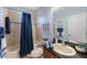 Clean bathroom with tub shower, vanity, and dark countertop at 7418 S Morton St, Tampa, FL 33616