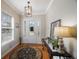 Bright entryway with hardwood floors, a chandelier, and a console table at 7418 S Morton St, Tampa, FL 33616