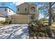 Two-story house with a two-car garage and nicely landscaped front yard at 7418 S Morton St, Tampa, FL 33616