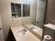 Bathroom with single sink vanity and shower/tub combo at 8313 Shallow Creek Ct, New Port Richey, FL 34653