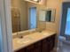 Double vanity bathroom with a large mirror and shower at 8313 Shallow Creek Ct, New Port Richey, FL 34653