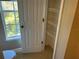 Small bathroom with a linen closet and window at 8313 Shallow Creek Ct, New Port Richey, FL 34653