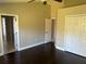 Primary bedroom with dark hardwood floors and ample closet space at 8313 Shallow Creek Ct, New Port Richey, FL 34653