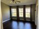 Spacious bedroom with dark hardwood floors and large windows at 8313 Shallow Creek Ct, New Port Richey, FL 34653