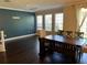 Bright dining area features dark hardwood floors and large windows at 8313 Shallow Creek Ct, New Port Richey, FL 34653