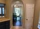 View of dining room from kitchen, showcasing hardwood floors at 8313 Shallow Creek Ct, New Port Richey, FL 34653