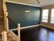 Spacious living room featuring dark hardwood floors and a large accent wall at 8313 Shallow Creek Ct, New Port Richey, FL 34653