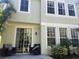 Townhome's rear exterior with sliding glass doors and patio at 8313 Shallow Creek Ct, New Port Richey, FL 34653