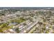 Aerial view of community featuring numerous homes, a pool, and shuffleboard at 8330 Vendome N Blvd, Pinellas Park, FL 33781