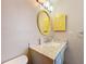 Bright bathroom with an oval mirror and yellow shutters at 8330 Vendome N Blvd, Pinellas Park, FL 33781